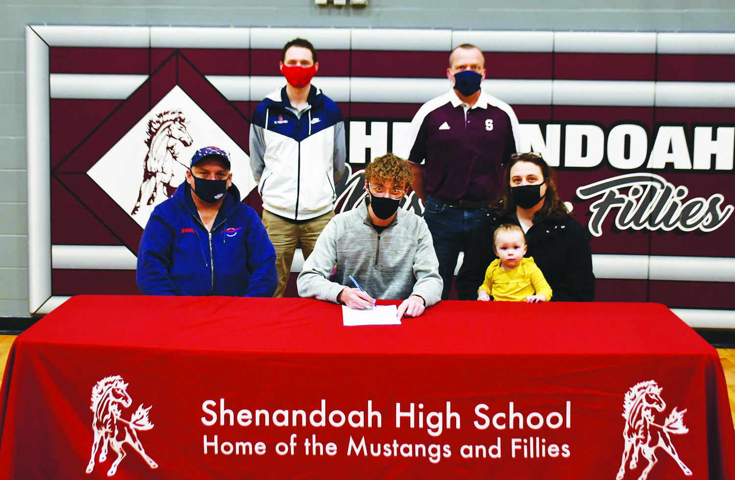 Bryce McDowell, center, signs his National Letter of Intent to run cross county at Southwestern Community College next fall. Pictured, in front from left, are, Kevin McDowell, Bryce's father; Bryce McDowell; Linda McDowell, Bryce's mother; and Amelia Judy, Bryce's niece. In back, from left, are Southwestern Director of Cross Country/Track and Field Scott Vicker, and Shenandoah High School Cross Country Coach Andy Campbell.