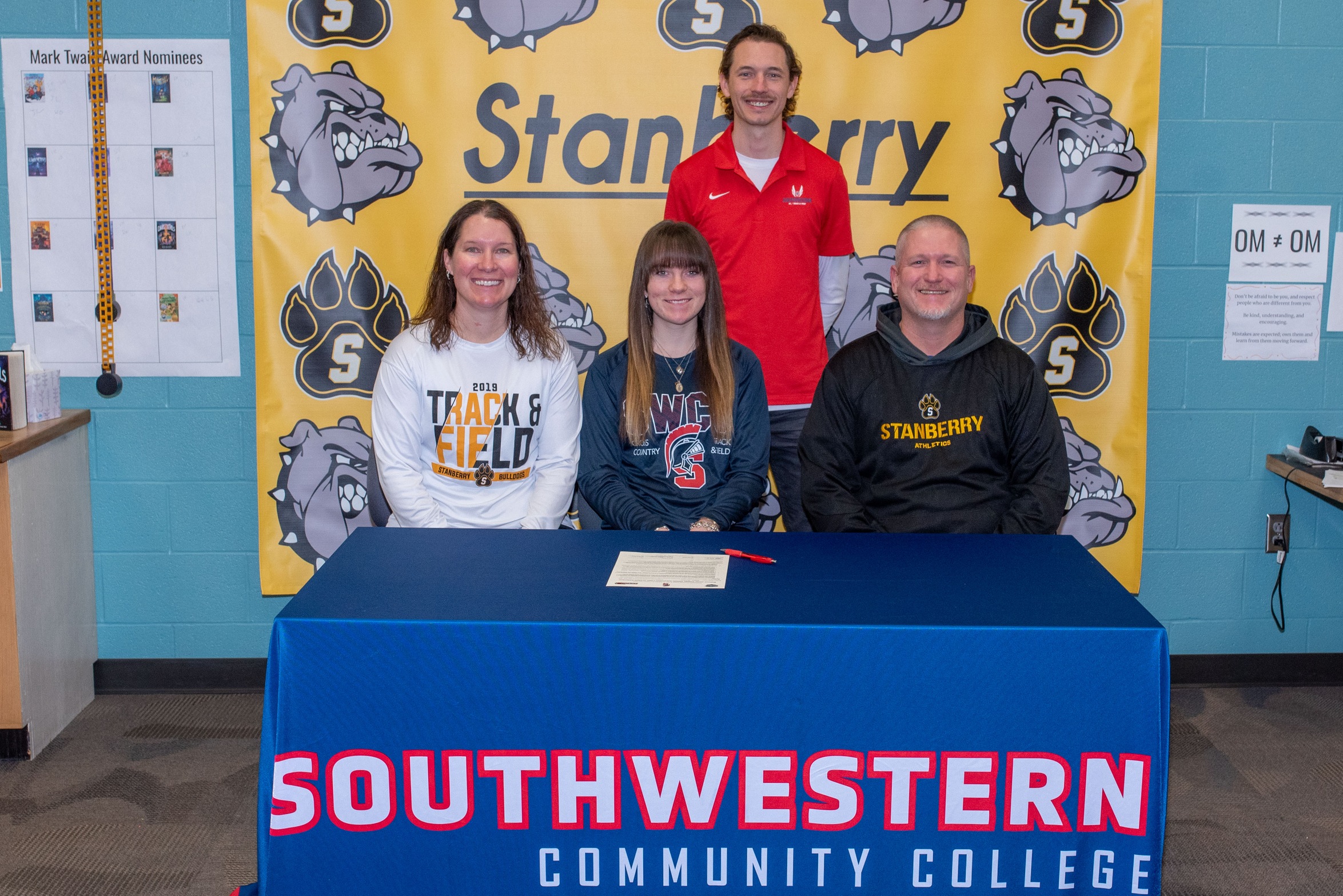 Marli Hilton, in front center, signs her National Letter of Intent to join the SWCC track & field team. She is joined in front by her parents Kelli and Shane Hilton. In back is Scott Vicker, SWCC director of cross country/track & field.
