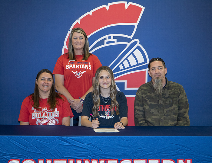 Sitting: Dani Meyer, Haylee's mother; Haylee Meyer; and Andy Meyer, Haylee's father. Standing: Tessa Otto, Southwestern assistant softball coach.